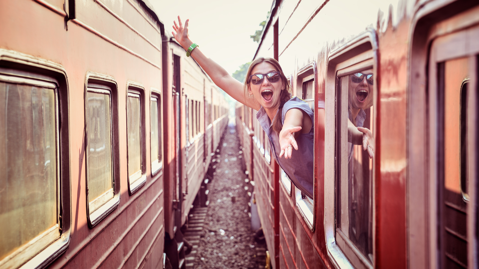 cheerful woman on train 1920 x 1080